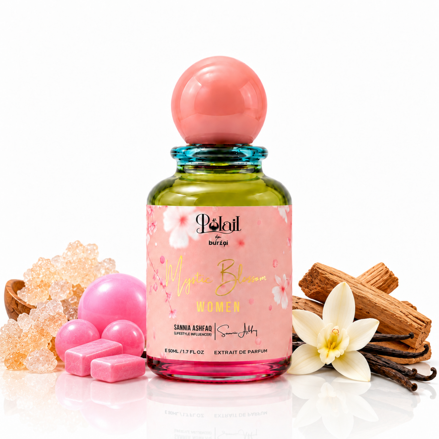 A perfume bottle labeled 'Polail by burzai Mystic Bloom' women's perfume with a pink label and a pink spherical cap, styled with pink wax melts, a vanilla flower, cinnamon sticks, and crystal on a white background.